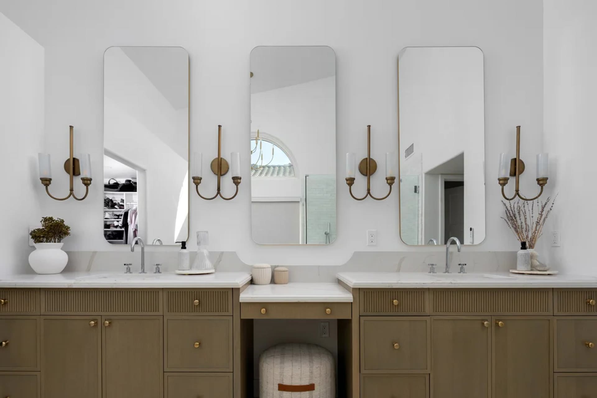 A dual vanity in oak millwork, marble, and tall bronze-framed mirrors. Across the Room, Paradise Valley, Desert Dwelling.