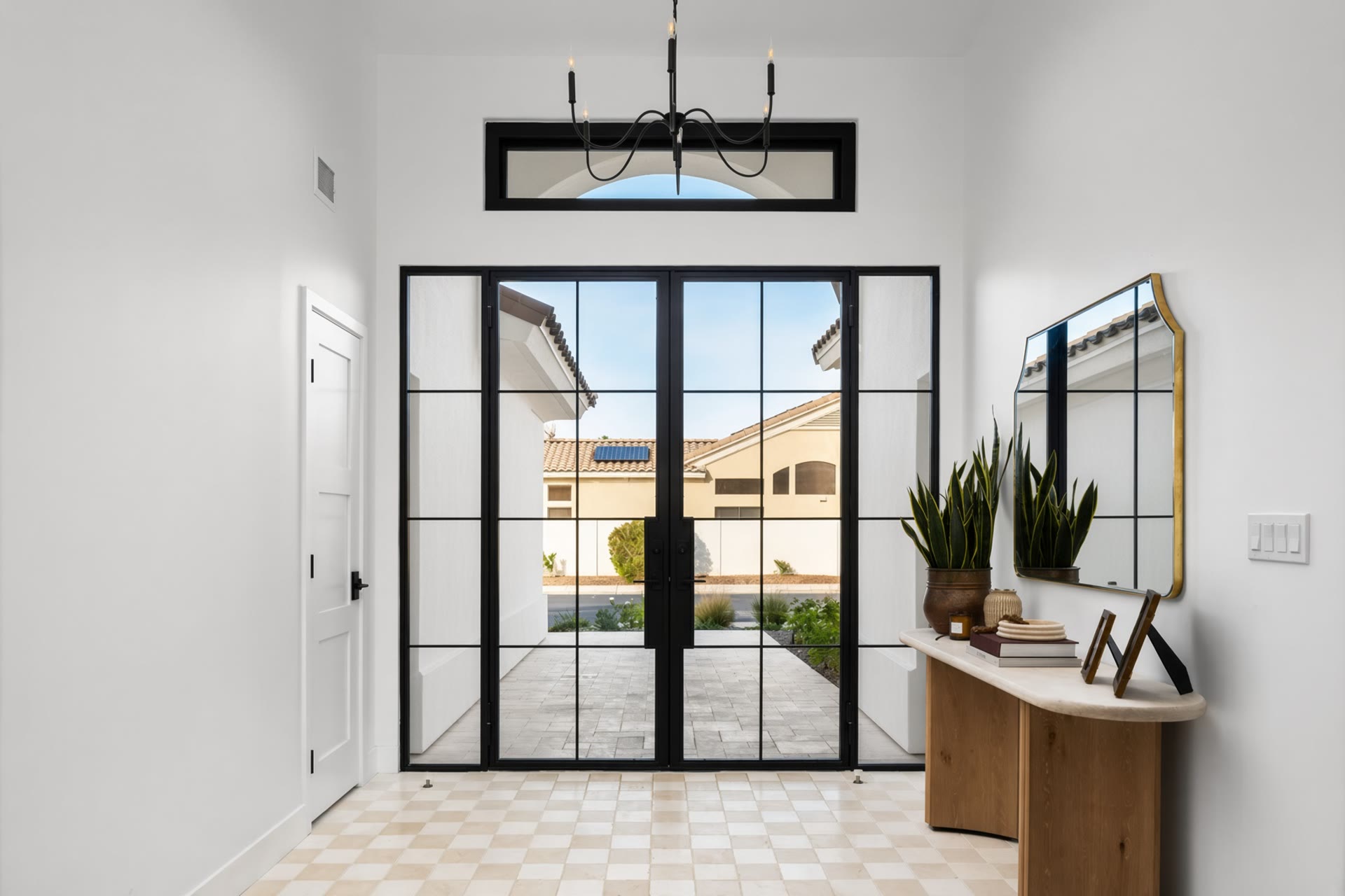 The steel grid entry opening to a paved court. Across the Room, Paradise Valley, Desert Dwelling.
