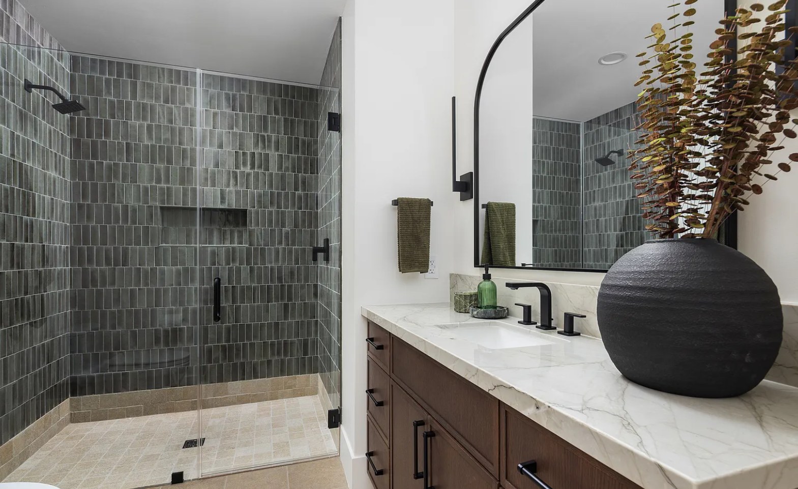 A bath of green zellige, marble, and an arched black mirror. I, Run, Paradise Valley, Desert Dwelling.