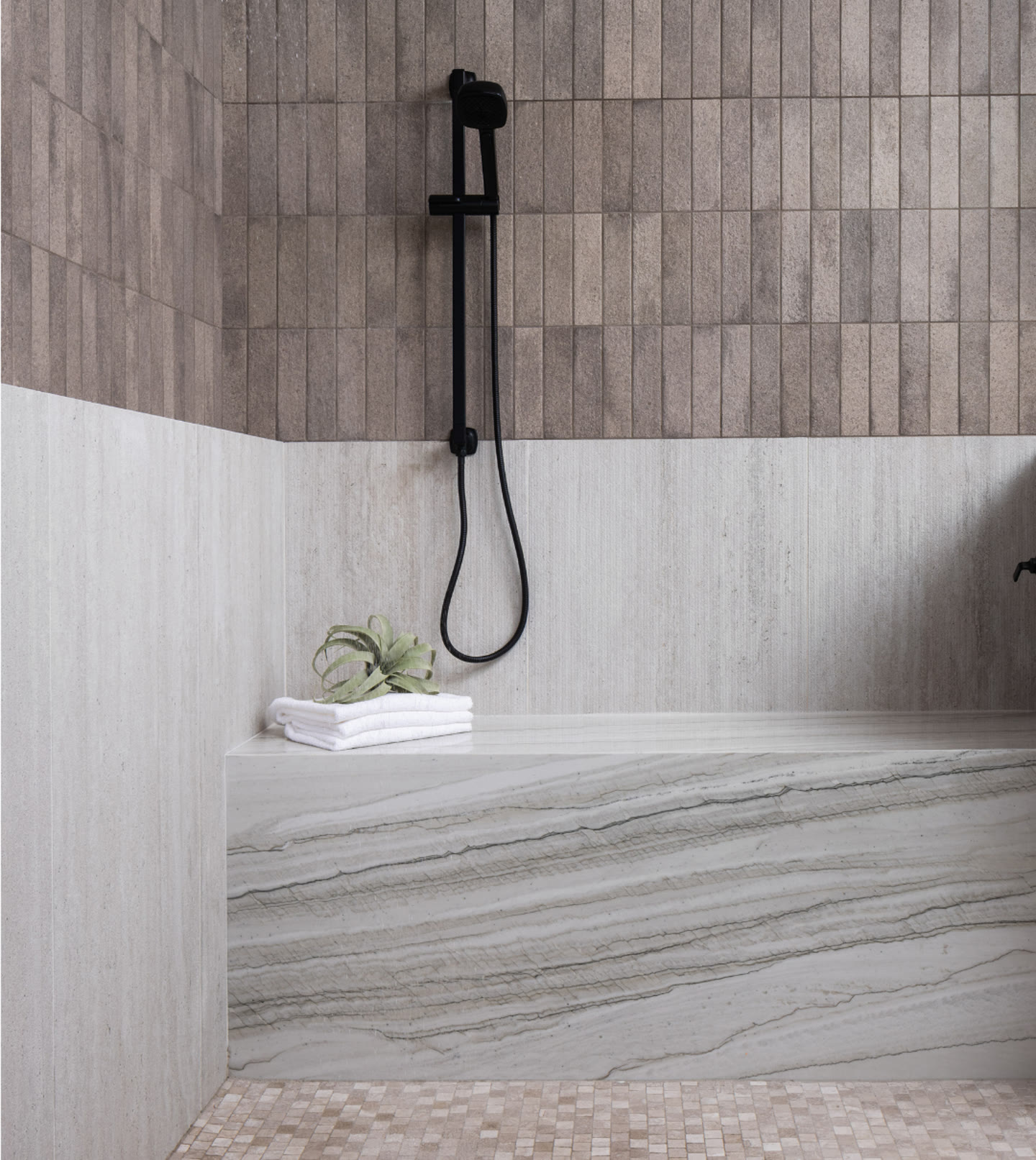 A marble shower with a black rain head and a niche of folded linen. I, Run, Paradise Valley, Desert Dwelling.