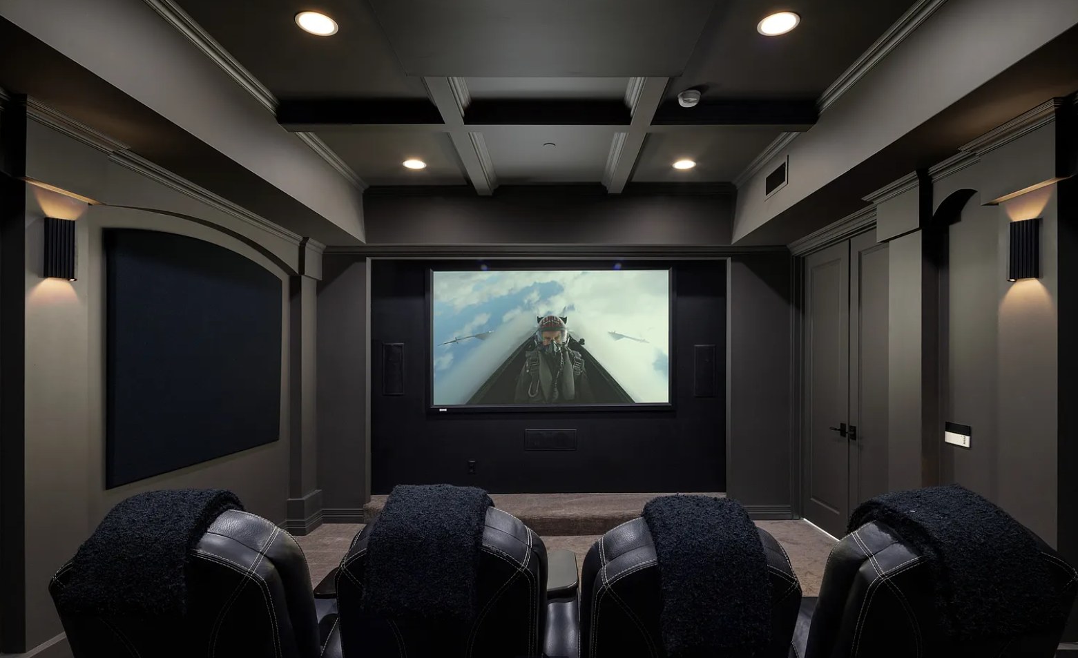 A dark paneled theater with leather chairs and a wide screen. I, Run, Paradise Valley, Desert Dwelling.