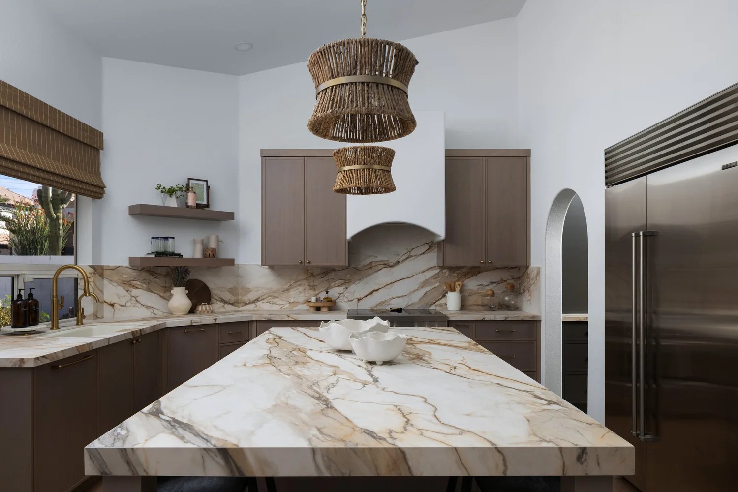 Taupe millwork kitchen with veined marble and woven pendants. New Beginnings, Scottsdale, Desert Dwelling.