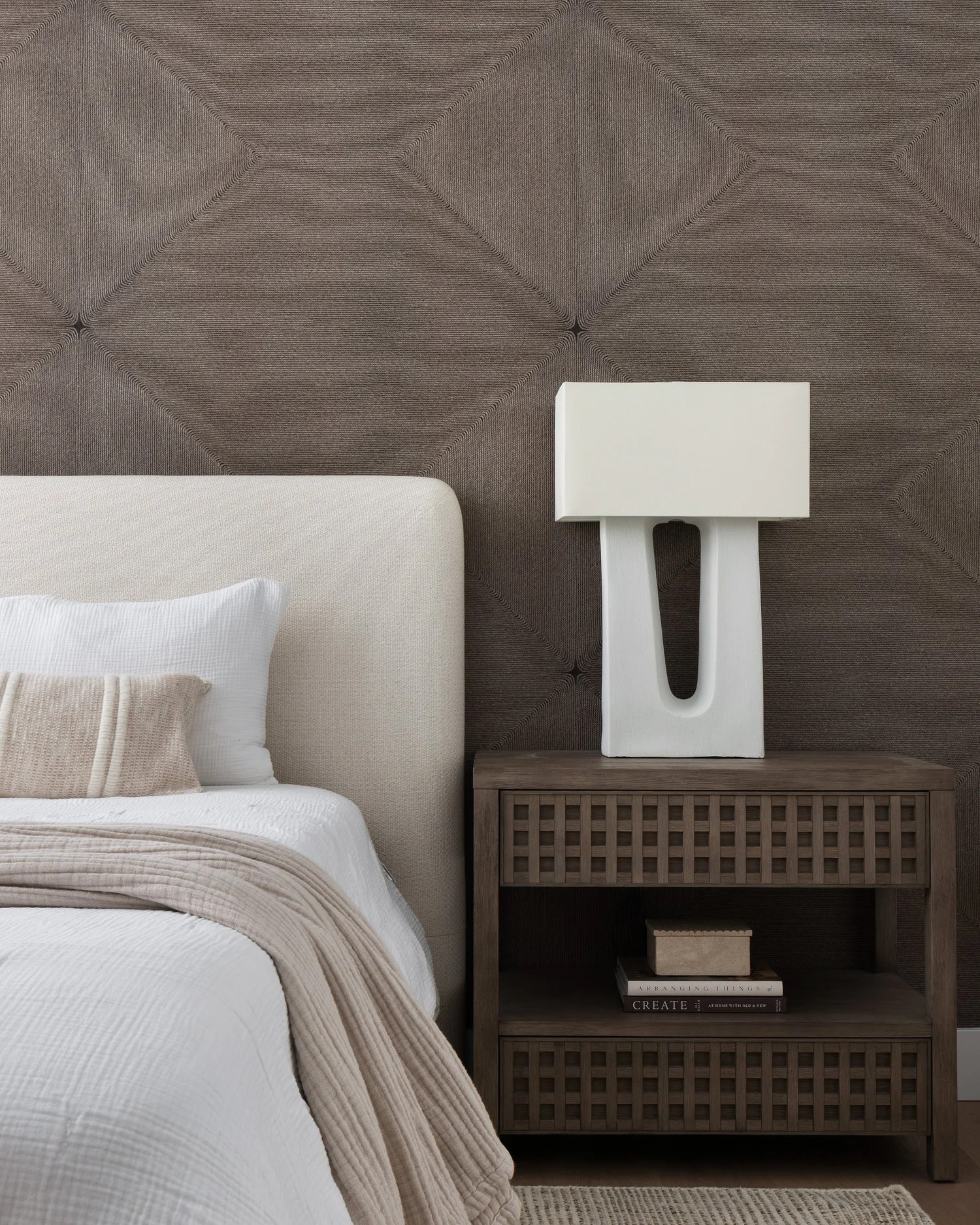 A lattice oak nightstand, a sculptural white lamp, and a diamond-tufted wall. New Beginnings, Scottsdale, Desert Dwelling.