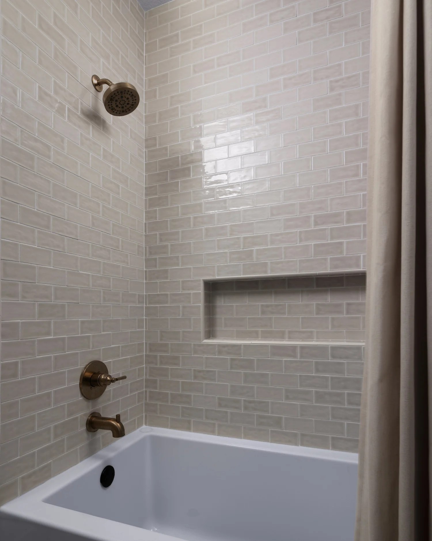Glazed subway tile, brass fittings, and a linen curtain at the tub. New Beginnings, Scottsdale, Desert Dwelling.