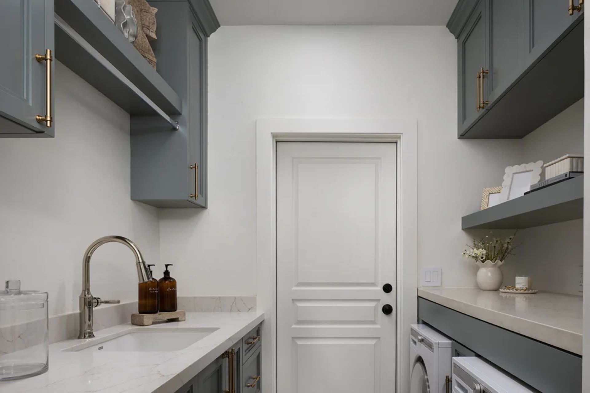 The laundry in blue-gray millwork, marble, and brass. Tuckey, Scottsdale, Desert Dwelling.