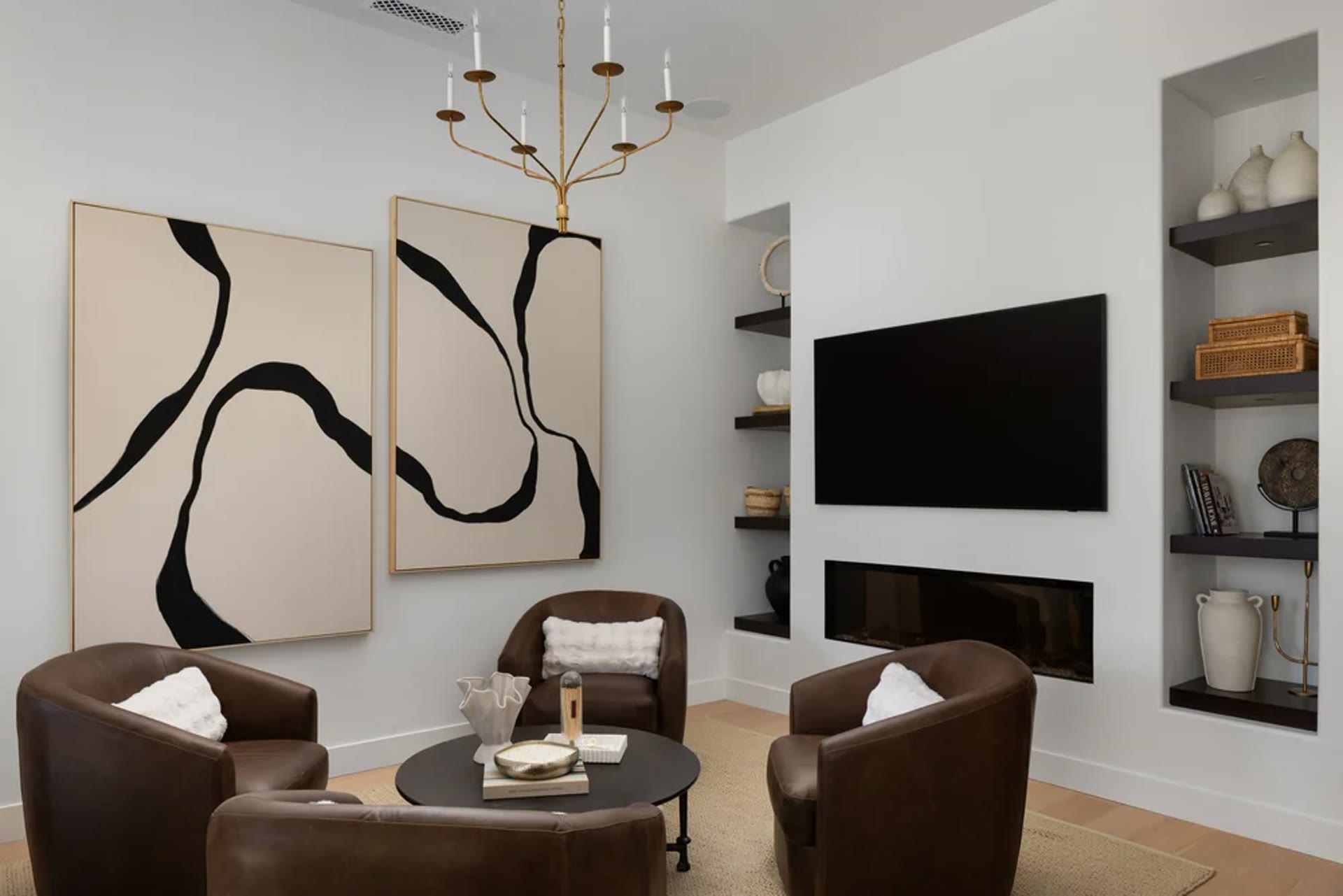 A sitting room of leather chairs, a linear fireplace, and paired abstract canvases. Tuckey, Scottsdale, Desert Dwelling.